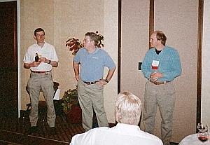 Three of the sponsors of the First Annual Extreme Beowulf Bash--Jim Cownie of Etnus (left), Douglas Eadline of Paralogic, Inc. (center), and Donald Becker of Scyld Computing Corporation (right)--discuss Beowulf Technology.